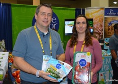 Chris Veillon with Pure Flavor and his colleague proudly show mini cucumbers as well as tomatoes from the company's greenhouse in Georgia.
